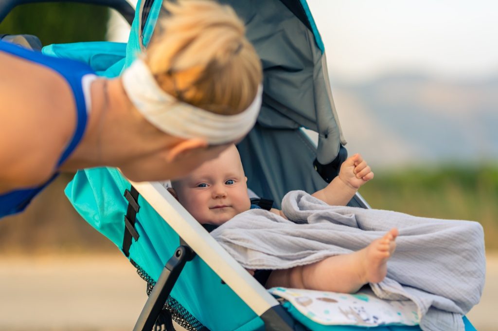 Mother looking at baby in jogging stroller
