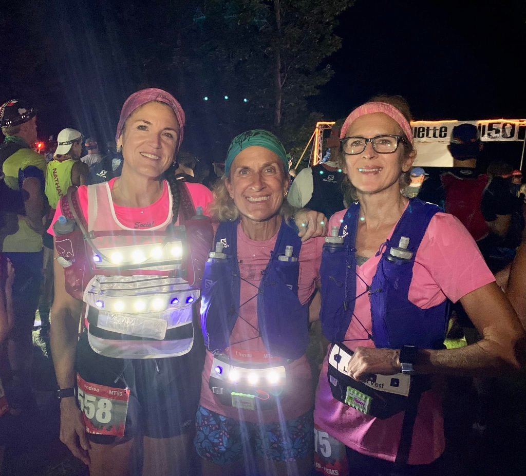3 women wearing the led light vest and belt