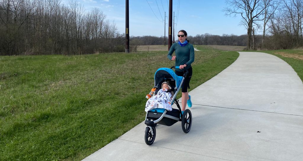 Laura Norris running her son in a stroller during her phase with postpartum depression