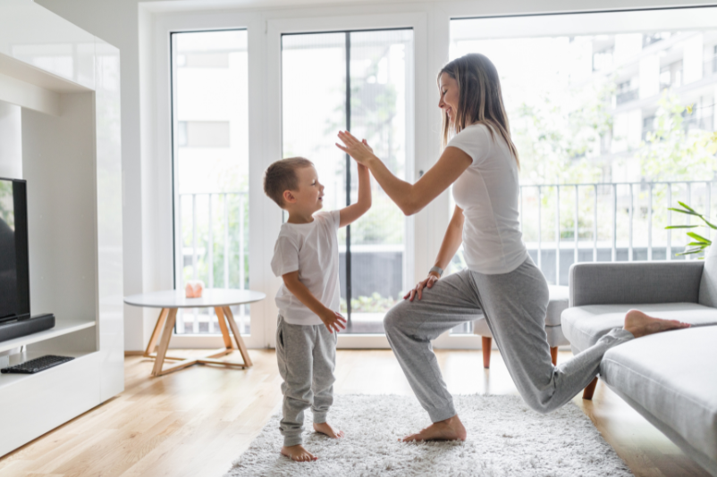 Busy mom exercising and giving son high five