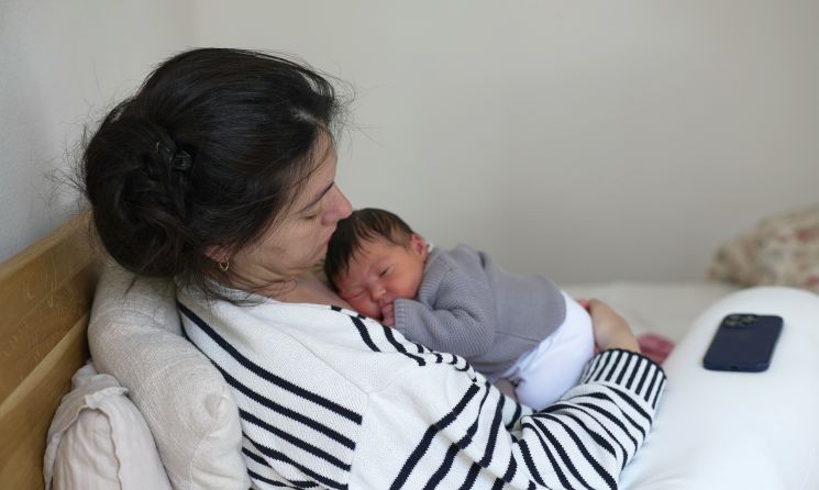 Charli Rohn holding her newborn baby