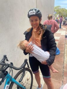 Clare Clark breastfeeding her baby during a Triathlon