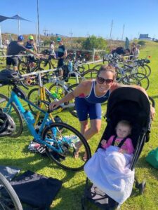 Clare Clark with her baby before starting a triathlon race