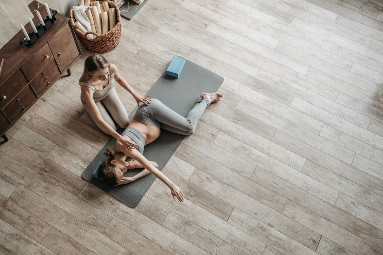 mom assisted by yogi for postpartum recovery