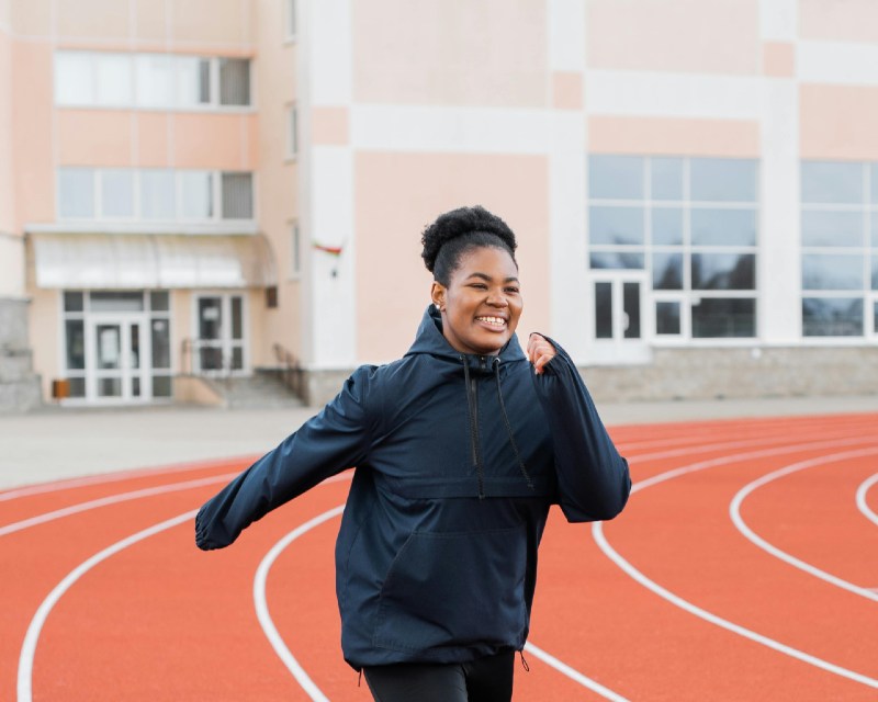 Woman smiling while running postpartum