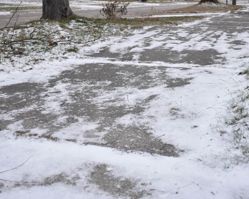 Snow running in icy sidewalks