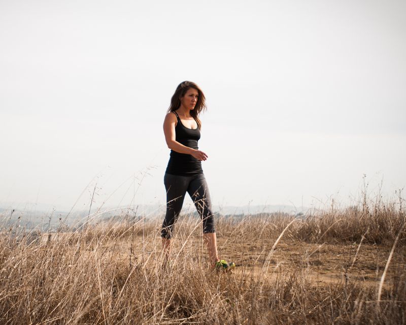 Focused mom exercising lightly before postpartum weight training.